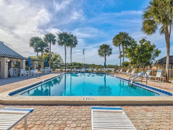 a view of swimming pool with outdoor seating and plants