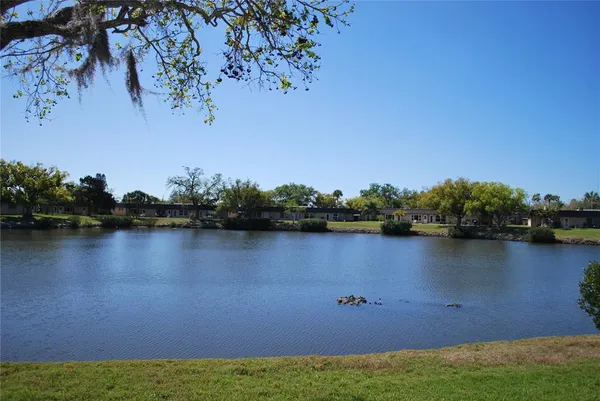 a view of a lake with houses in the background