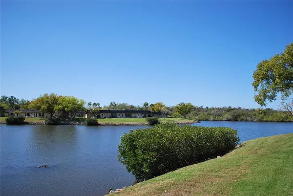 a view of a lake with houses in the back
