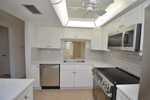 a kitchen with a stove and a microwave