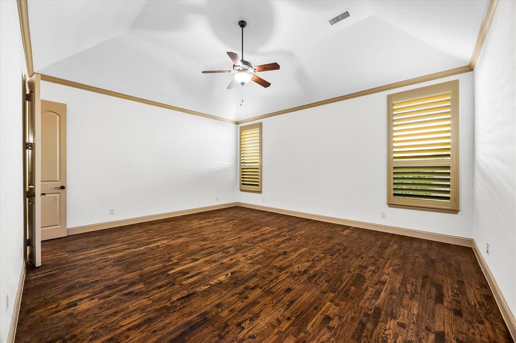 6814 Springwood Lane Garland, TX 75044 - Photo 20 of 35 a view of an empty room with wooden floor and a window