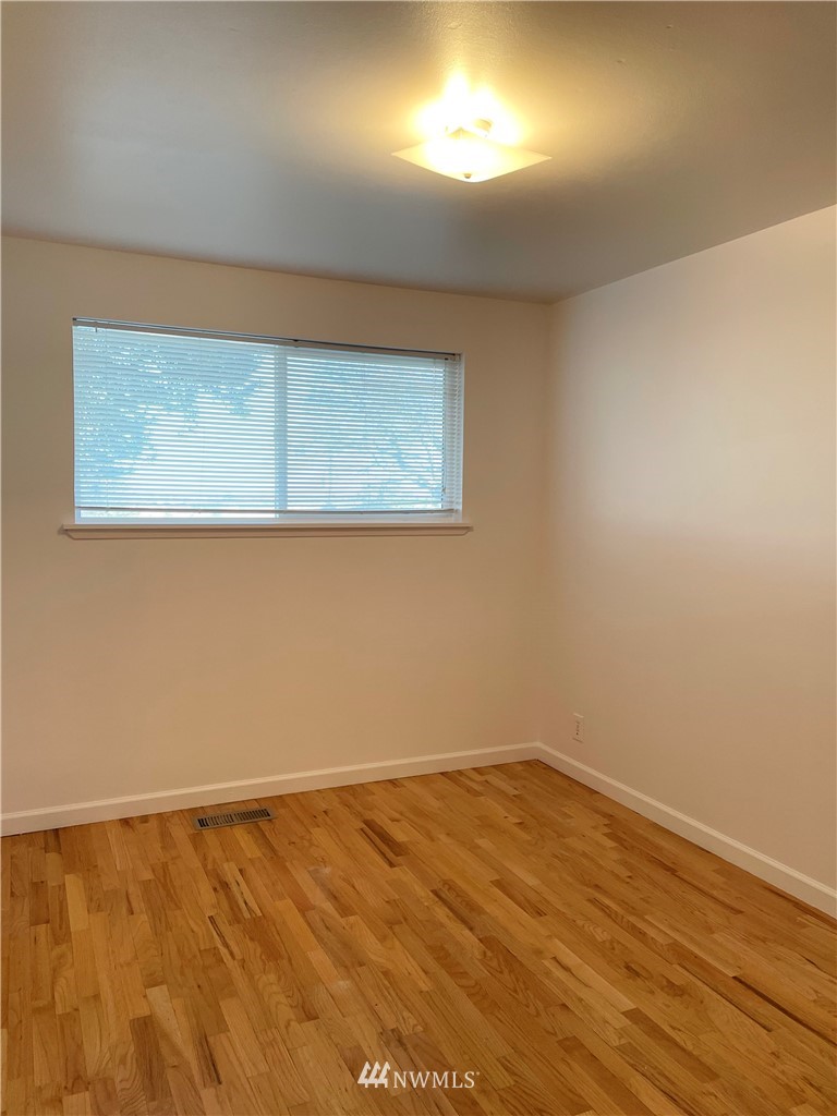 381 Patrick Road Ephrata, WA 98823 - Photo 20 of 32 a view of an empty room with wooden floor and a window