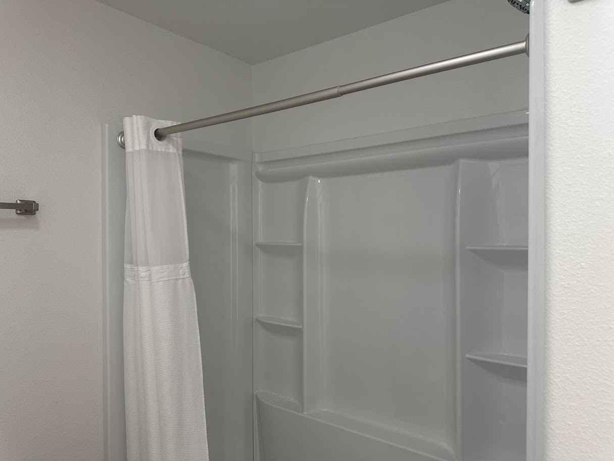 48 Vigilante Point Blank, TX 77364 - Photo 11 of 20 a bathroom with a glass shower door