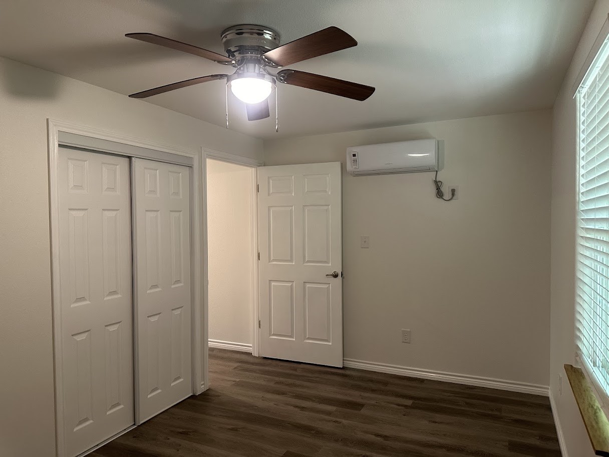 48 Vigilante Point Blank, TX 77364 - Photo 15 of 20 an empty room with wooden floor cabinet and windows