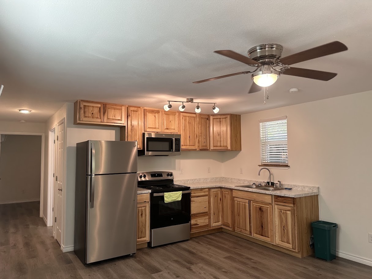 48 Vigilante Point Blank, TX 77364 - Photo 5 of 20 a kitchen with a refrigerator cabinets and wooden floor