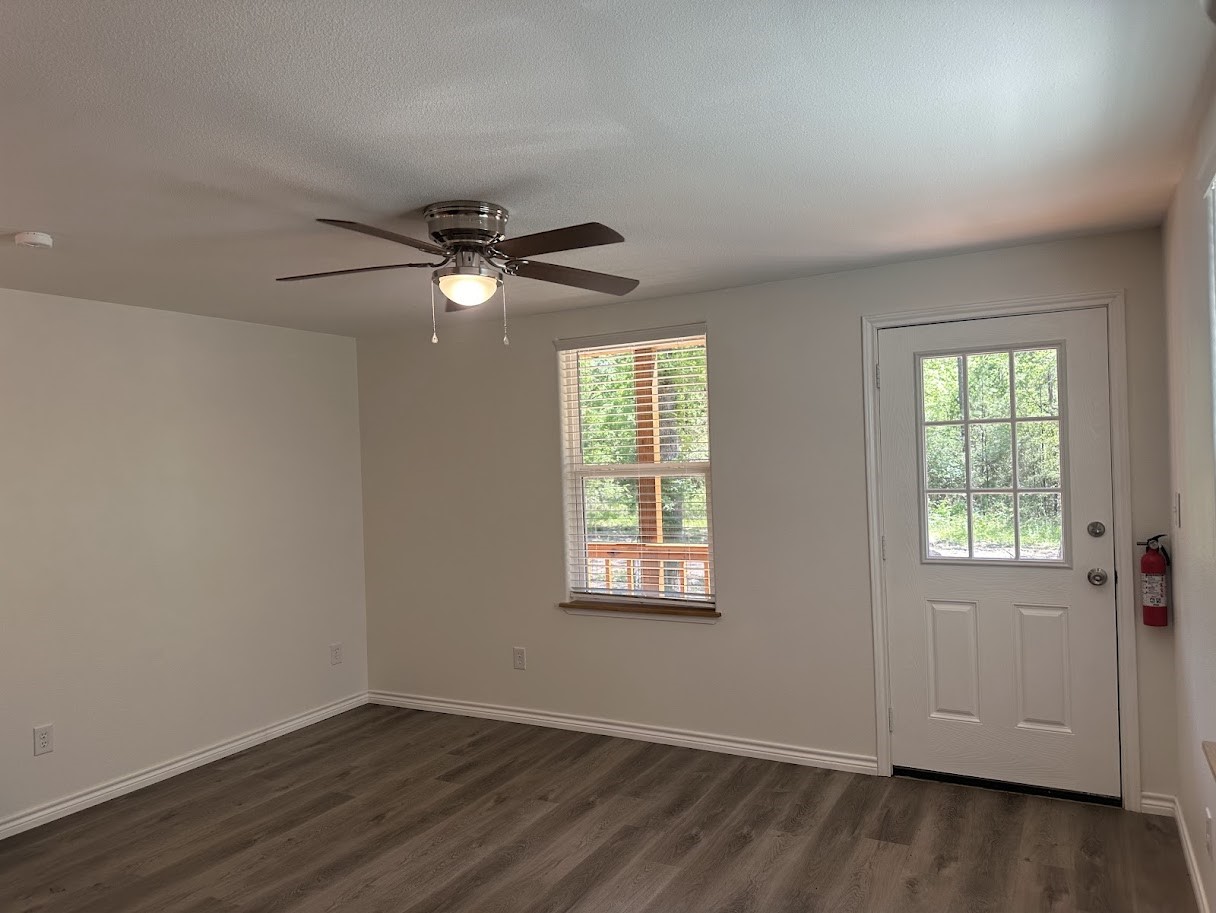 48 Vigilante Point Blank, TX 77364 - Photo 6 of 20 an empty room with wooden floor and windows