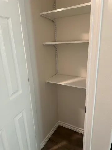 a view of a room with wooden floor