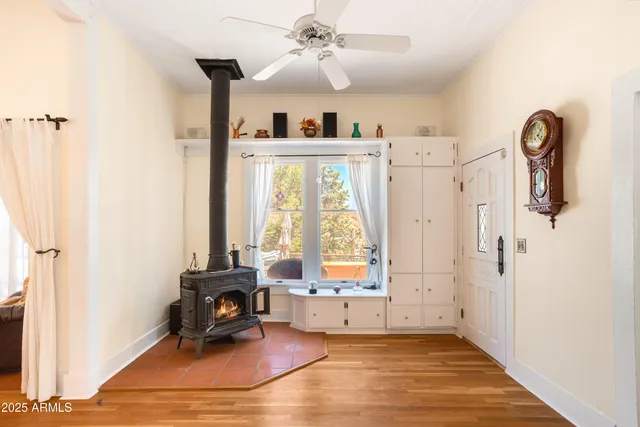 a view of a hallway with wooden floor and windows