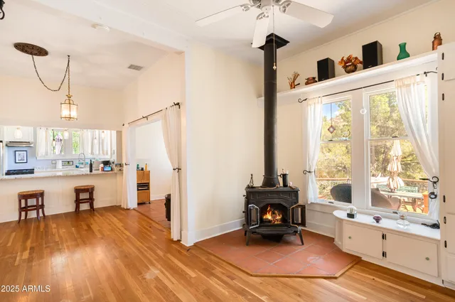 a view of a livingroom with wooden floor and a ceiling fan
