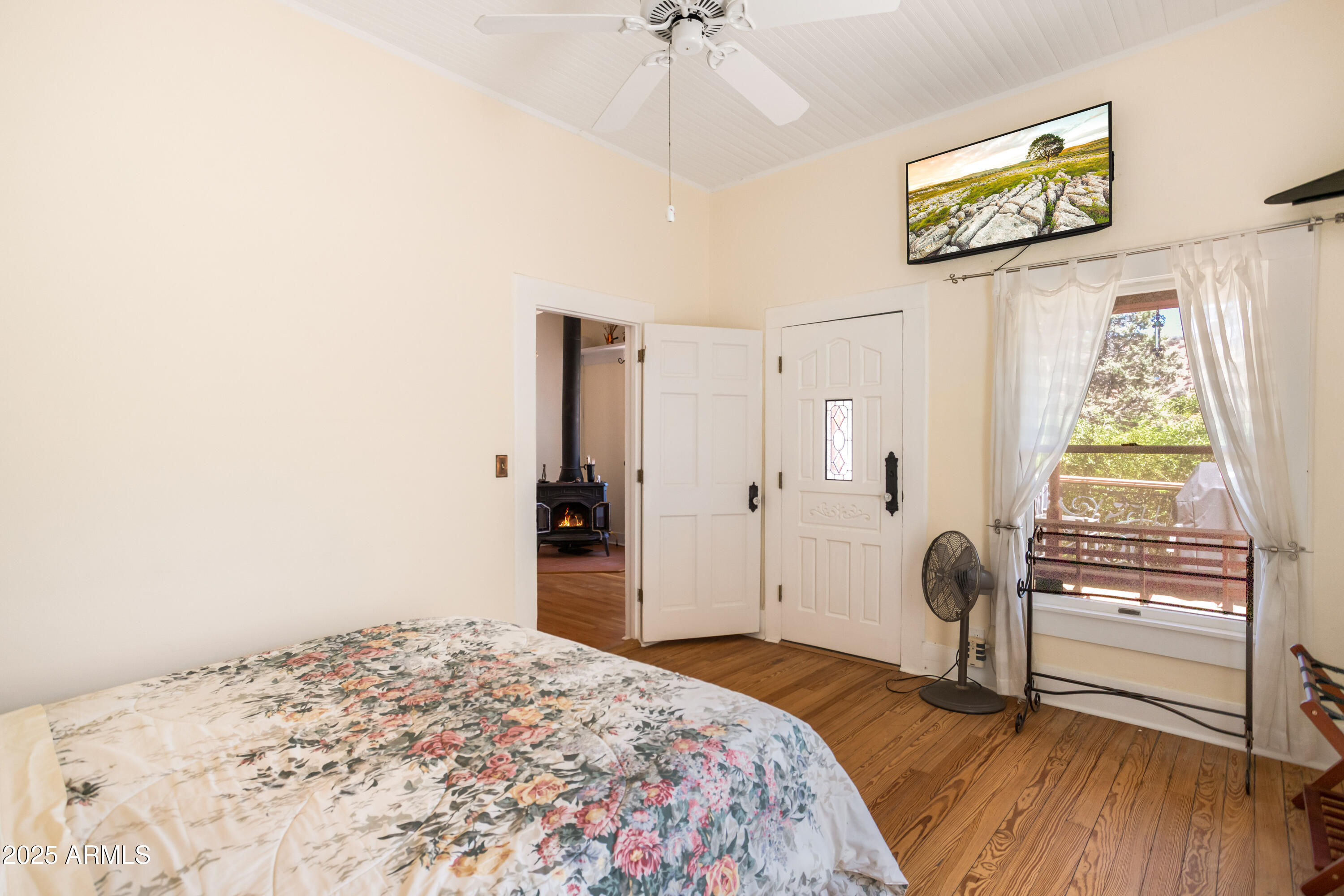 84 Shearer Avenue Bisbee, AZ 85603 - Photo 17 of 39 a bedroom with a bed and a chandelier