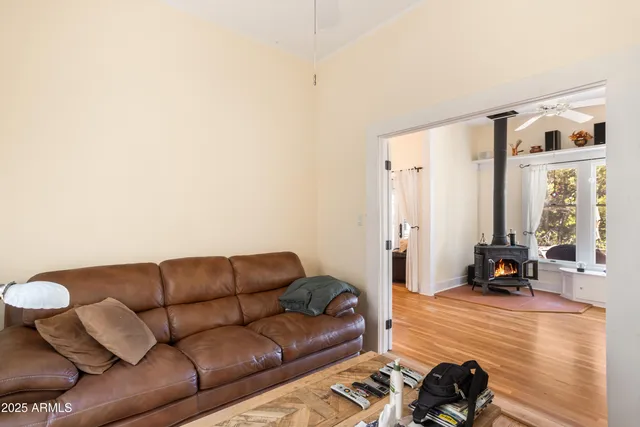 a living room with furniture a flat screen tv and a window