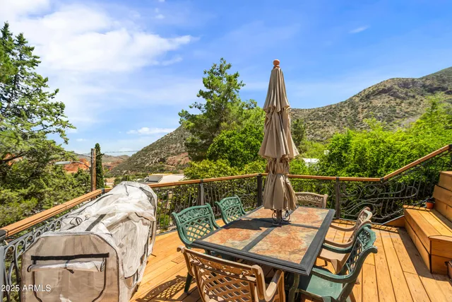 a view of a terrace with couches and wooden fence