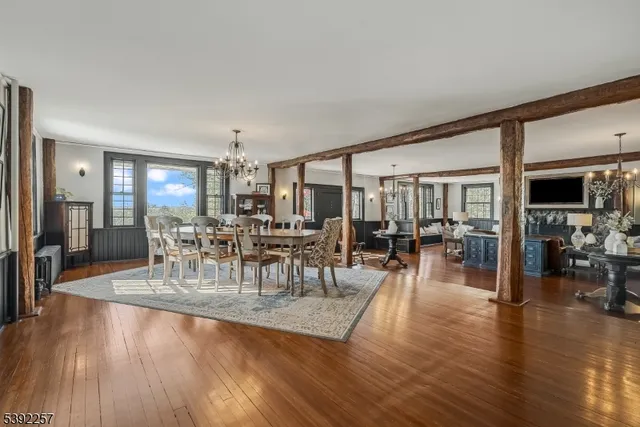 a kitchen with stainless steel appliances a dining table chairs stove and cabinets