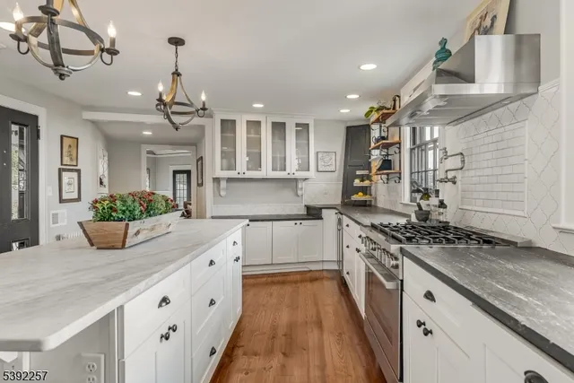 a living room with furniture fireplace and a large window