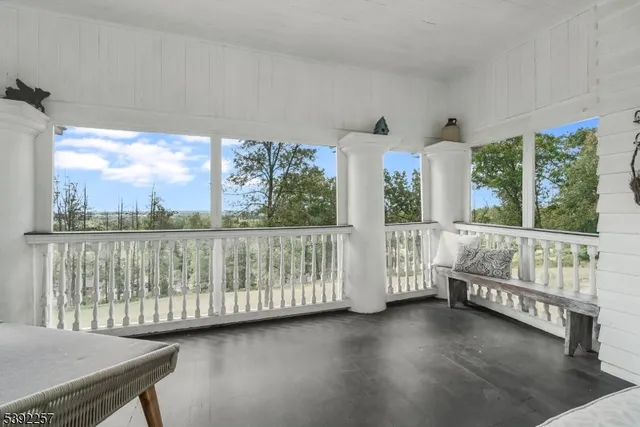a bathroom with a granite countertop toilet and a bathtub