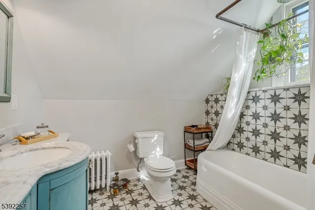 a bathroom with a toilet a sink and a window