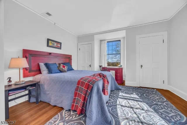 a bedroom with furniture and a flat screen tv