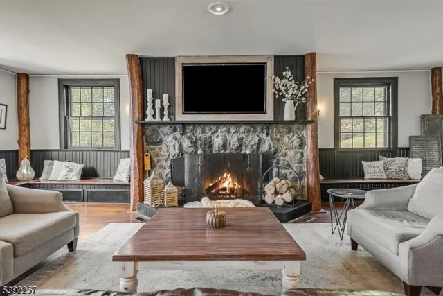 a living room with furniture a flat screen tv and a fireplace