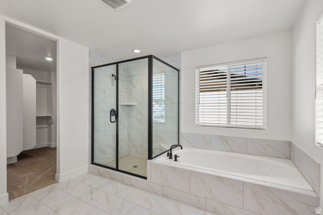 1661 West Ross Road Syracuse, UT 84075 - Photo 18 of 28 Bathroom with a shower stall, a garden tub, a walk in closet, and light marble finish floors
