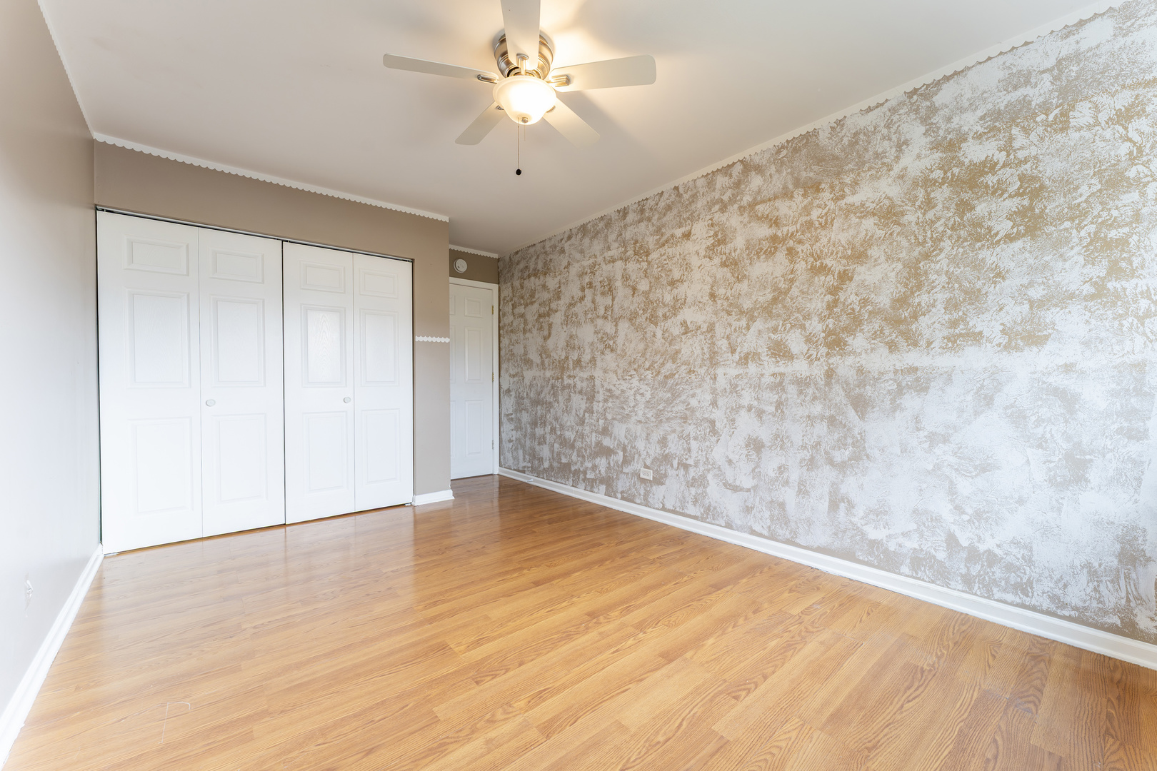 802 East Old Willow Road, Unit 114 Prospect Heights, IL 60070 - Photo 12 of 14 an empty room with a ceiling fan and carpet