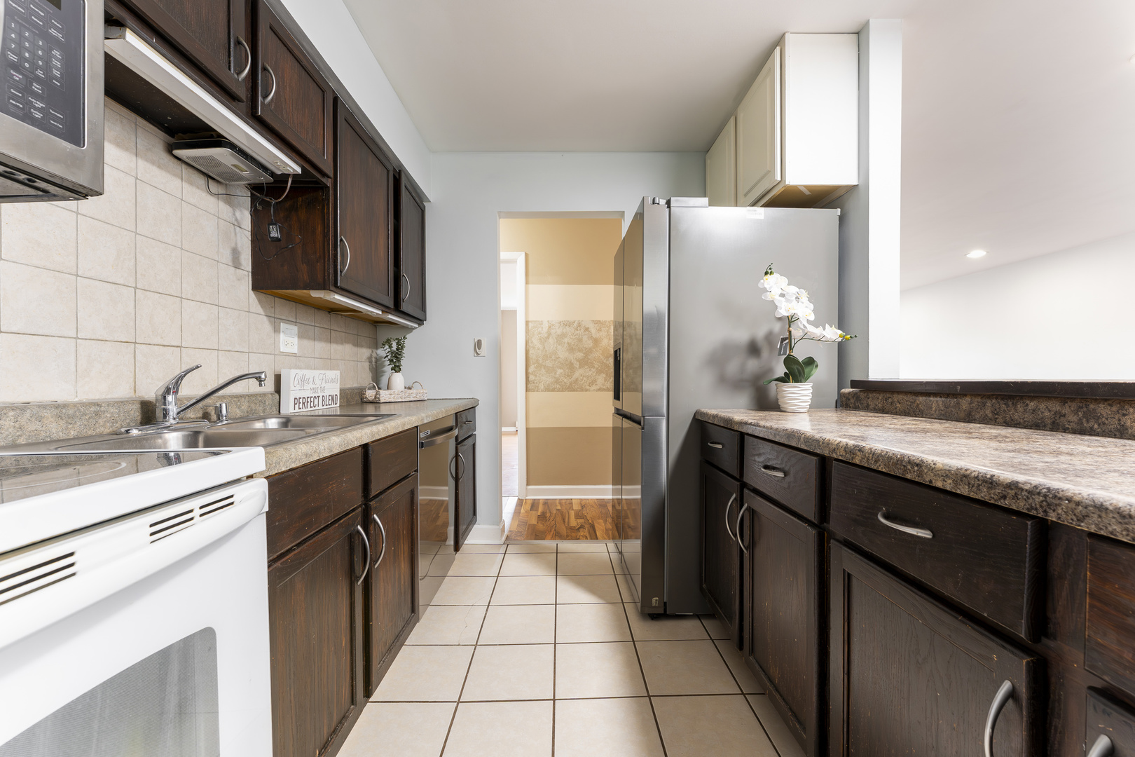 802 East Old Willow Road, Unit 114 Prospect Heights, IL 60070 - Photo 4 of 14 a kitchen with a sink stove and cabinets