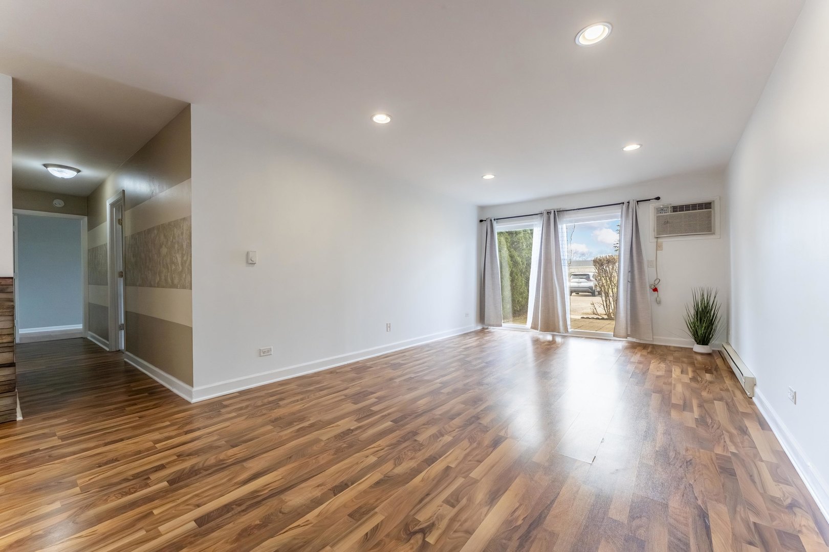 802 East Old Willow Road, Unit 114 Prospect Heights, IL 60070 - Photo 5 of 14 a view of an empty room with wooden floor and a window
