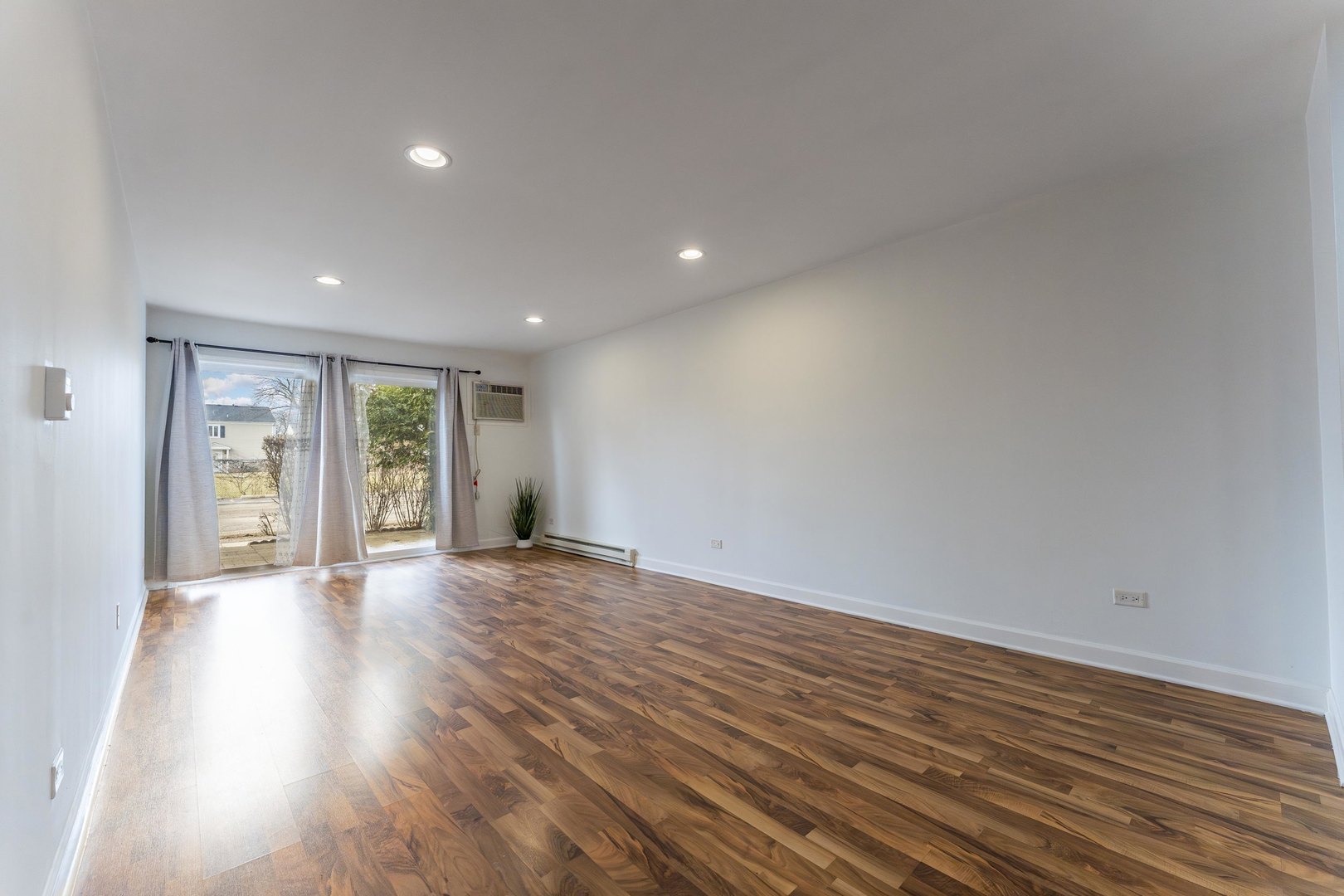 802 East Old Willow Road, Unit 114 Prospect Heights, IL 60070 - Photo 6 of 14 a view of an empty room with wooden floor and a window