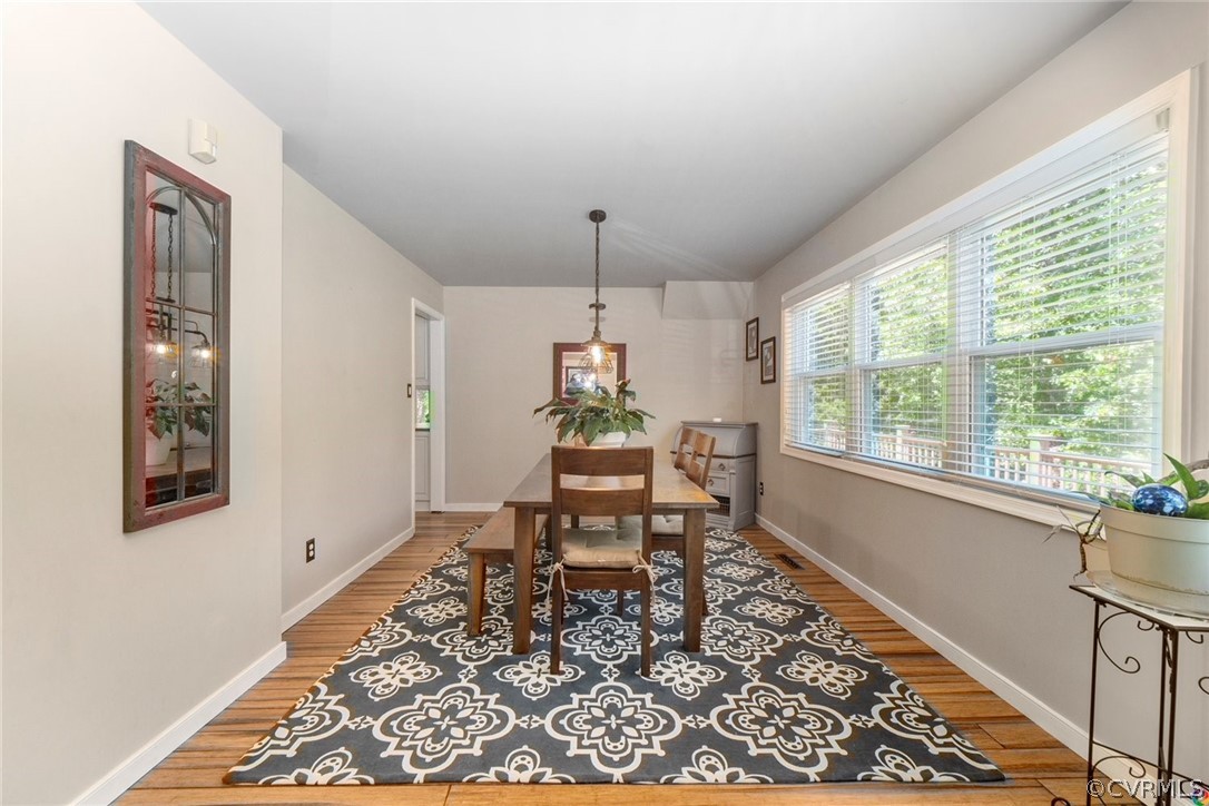 16001 Beach Road Chesterfield, VA 23838 - Photo 8 of 27 a dining room with wooden floor and a chandelier