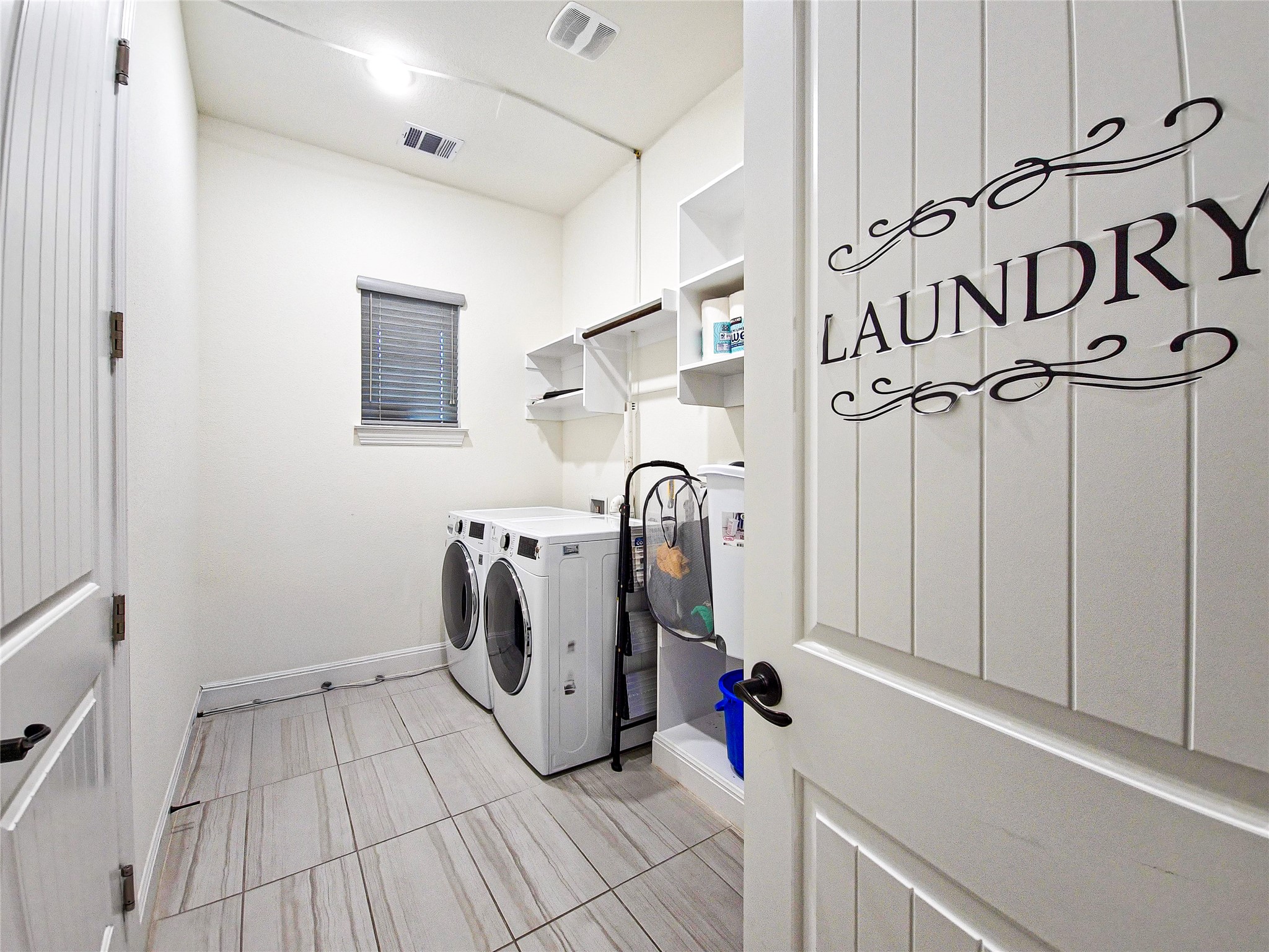 813 Sunny Ridge Drive Leander, TX 78641 - Photo 18 of 32 Functional laundry room offers sleek appliances and practical shelving.