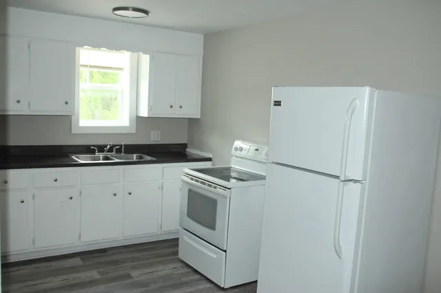 a kitchen with a refrigerator stove and sink