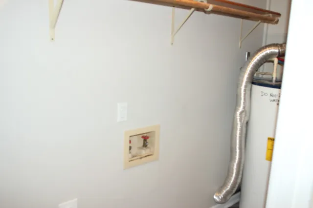 a view of a storage & utility room with a sink