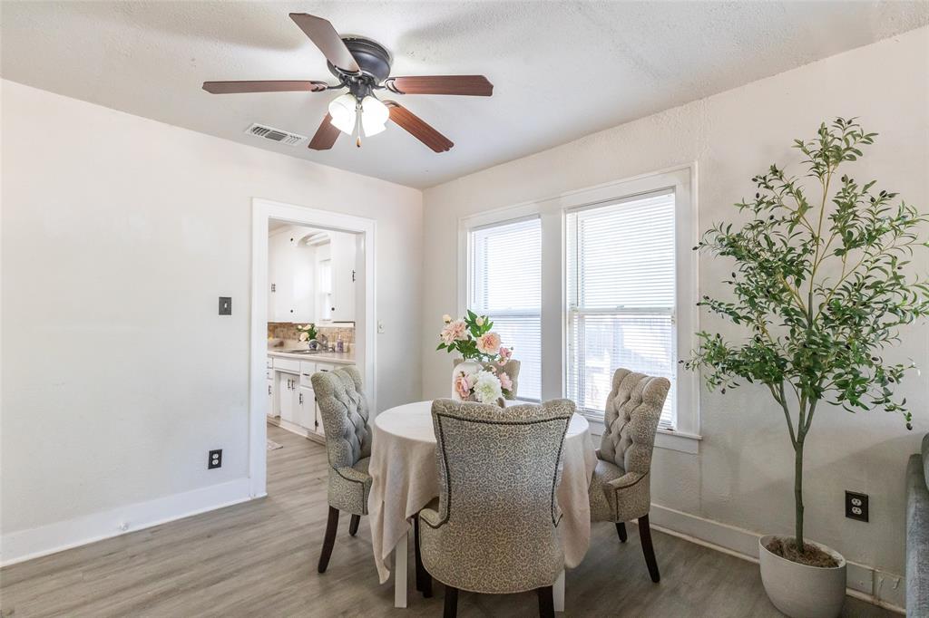 3349 South 3rd Street Abilene, TX 79605 - Photo 13 of 30 a dining room with furniture potted plants and wooden floor