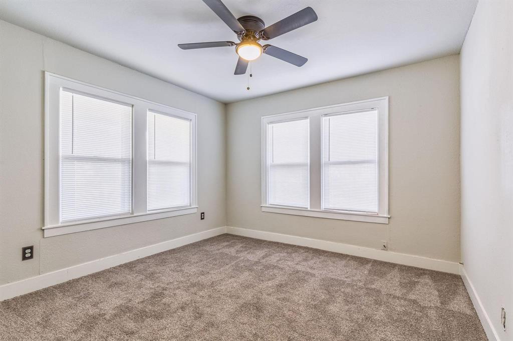 3349 South 3rd Street Abilene, TX 79605 - Photo 24 of 30 an empty room with chandelier fan and windows