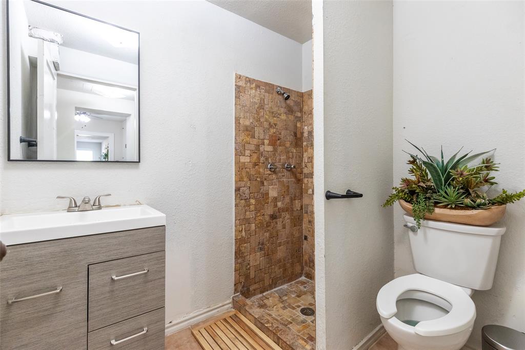 3349 South 3rd Street Abilene, TX 79605 - Photo 27 of 30 a bathroom with a toilet a sink and a mirror