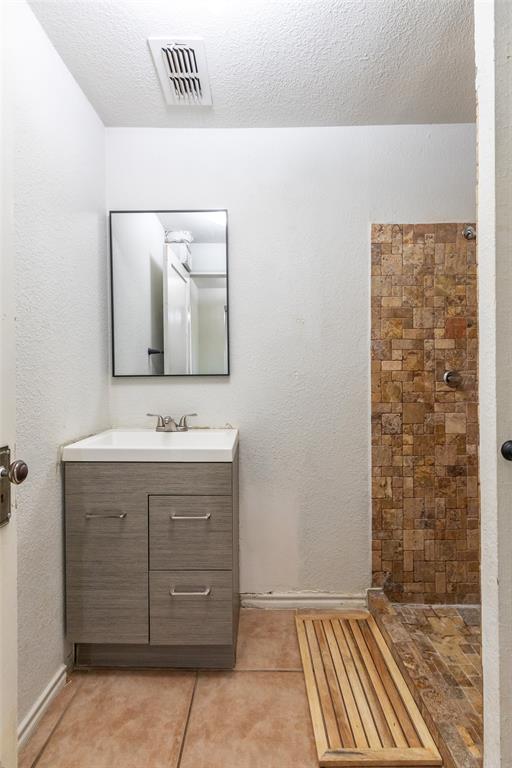 3349 South 3rd Street Abilene, TX 79605 - Photo 28 of 30 a bathroom with a sink a mirror and shower