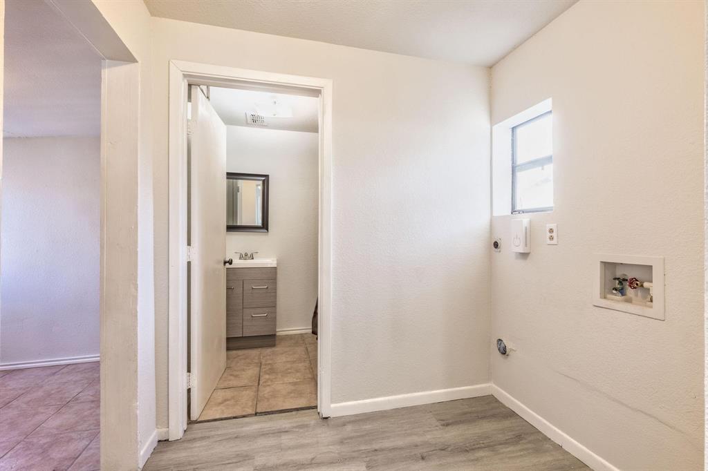 3349 South 3rd Street Abilene, TX 79605 - Photo 29 of 30 a view of a hallway with wooden floor and a bathroom