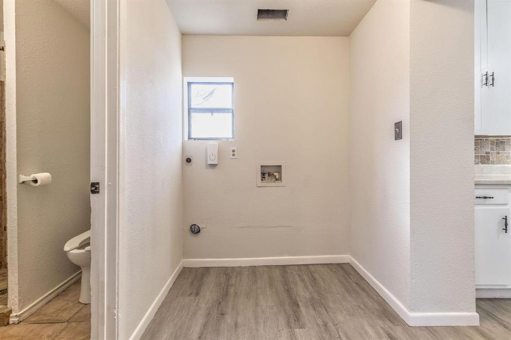 3349 South 3rd Street Abilene, TX 79605 - Photo 30 of 30 a view of a hallway with wooden floor and a bathroom
