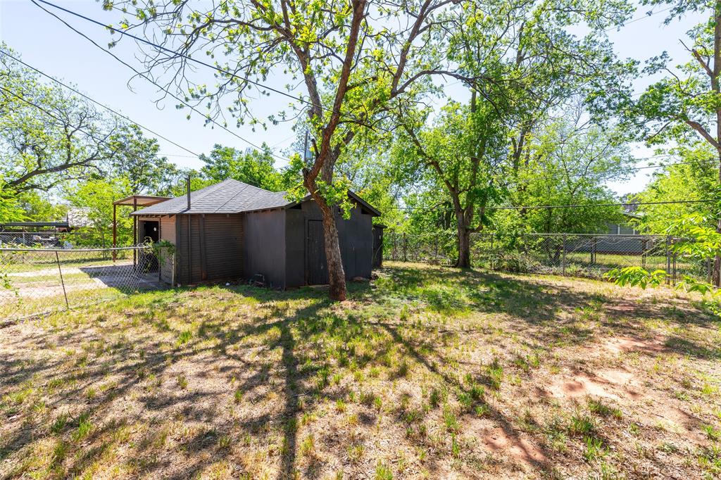 3349 South 3rd Street Abilene, TX 79605 - Photo 6 of 30 a yard with some trees in the background