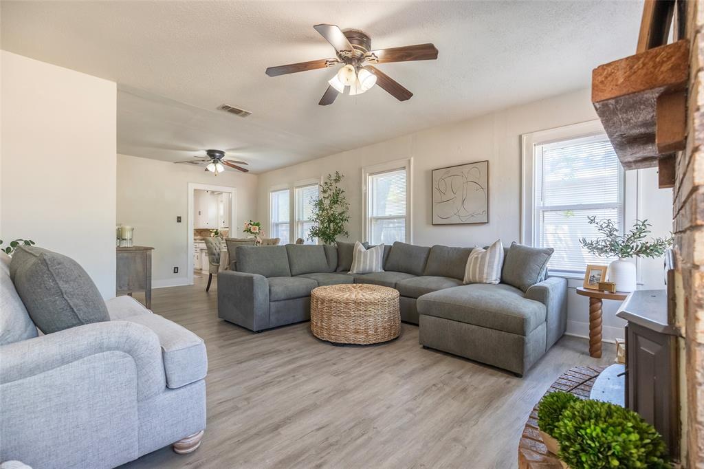 3349 South 3rd Street Abilene, TX 79605 - Photo 8 of 30 a living room with furniture a chandelier and a window