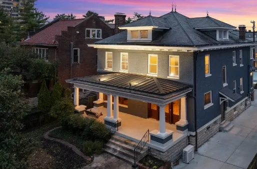 a front view of a house with garden space and balcony