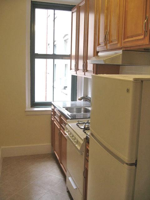 a kitchen with stainless steel appliances a sink and a window
