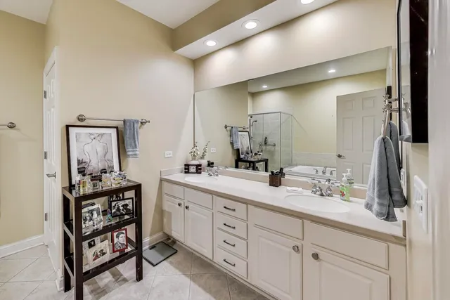 a spacious bathroom with a double vanity sink and a mirror