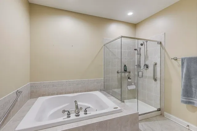 a bathroom with a bathtub and a shower