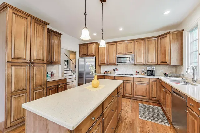a kitchen with refrigerator cabinets and wooden floor