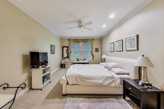 a spacious bedroom with a bed and a flat screen tv