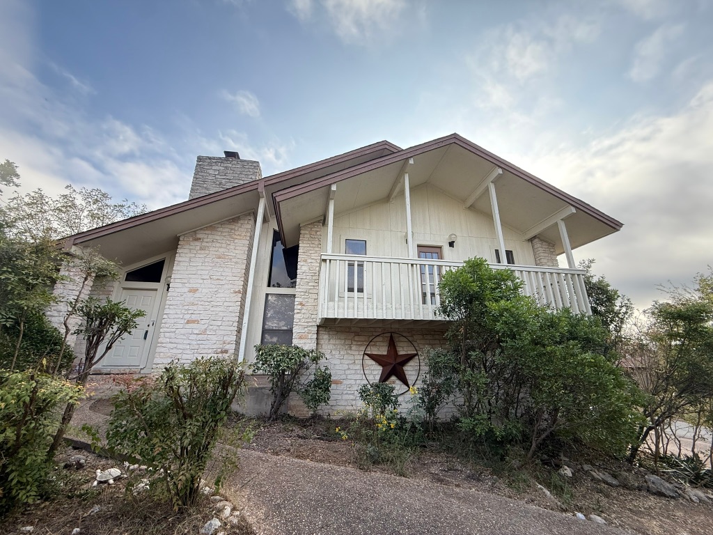 a front view of a house with plants
