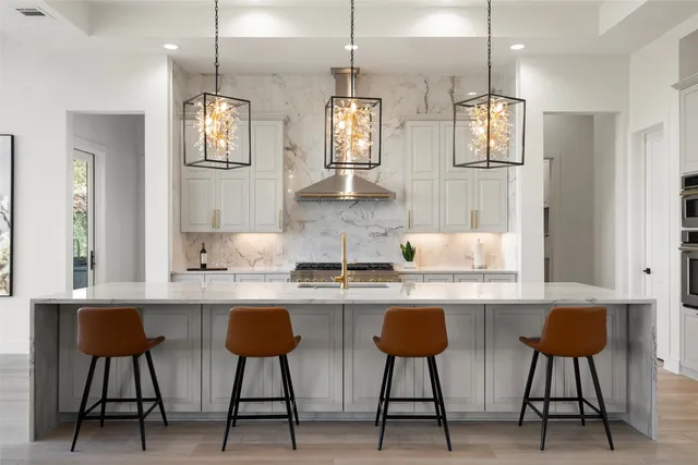 a view of a big room with wooden floor water view and windows