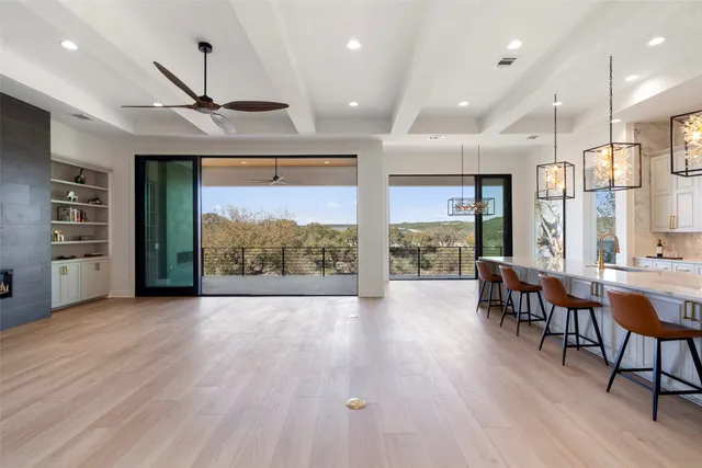 a view of a room with wooden floor and windows