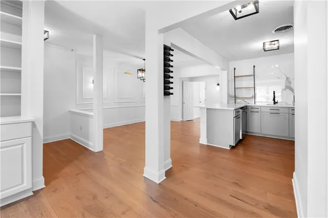 a view of an empty room with a fireplace and a window