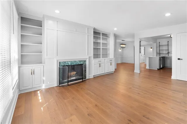 a view of a kitchen with wooden floor and a window